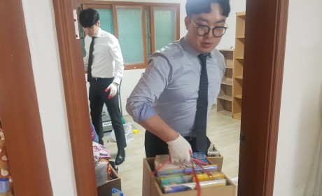 포장된 이삿짐을 나르는 자원봉사자들